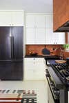 Modern Kitchen With White Cabinets and Terra Cotta Tile