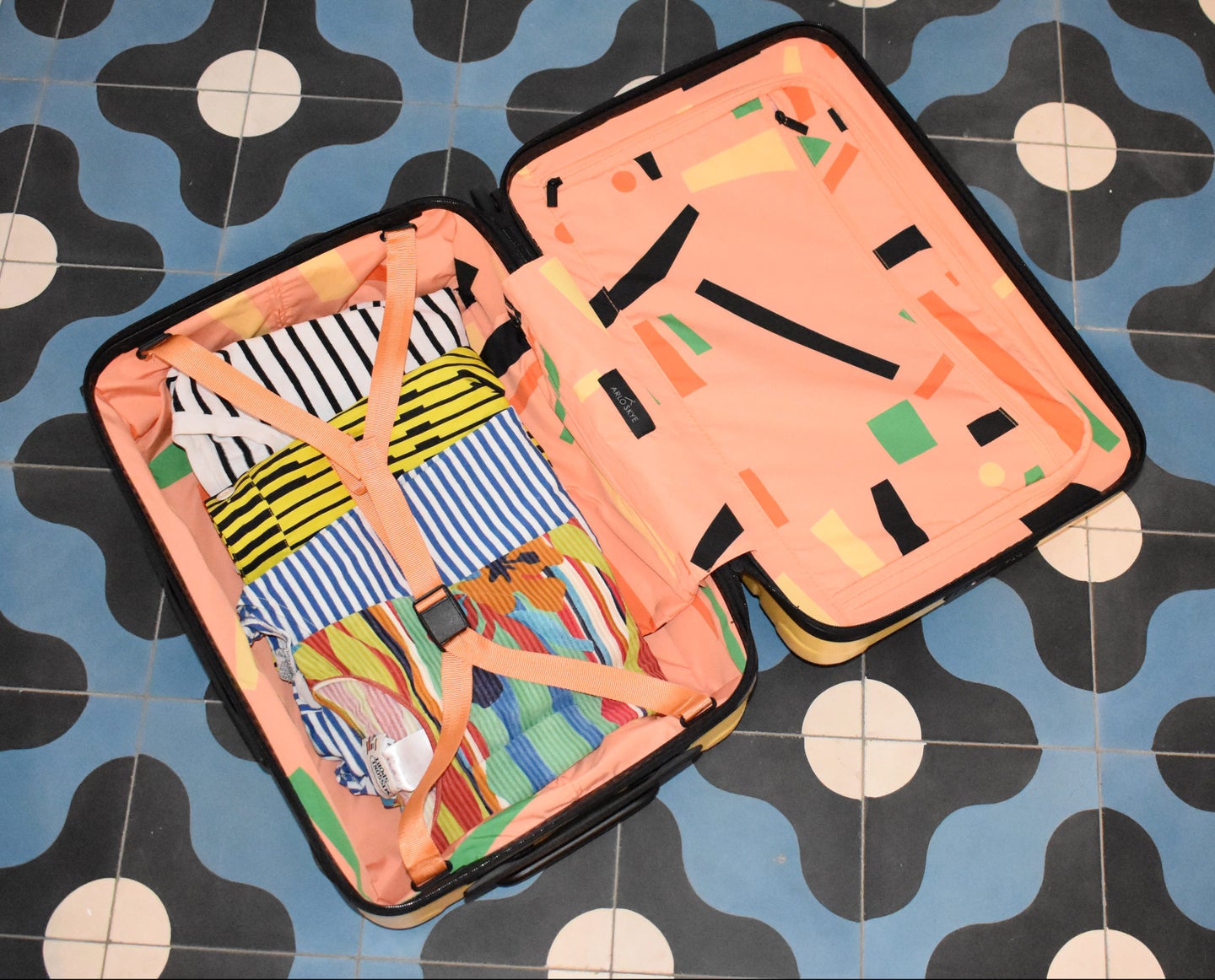 open-suitcase-on-tile-floor