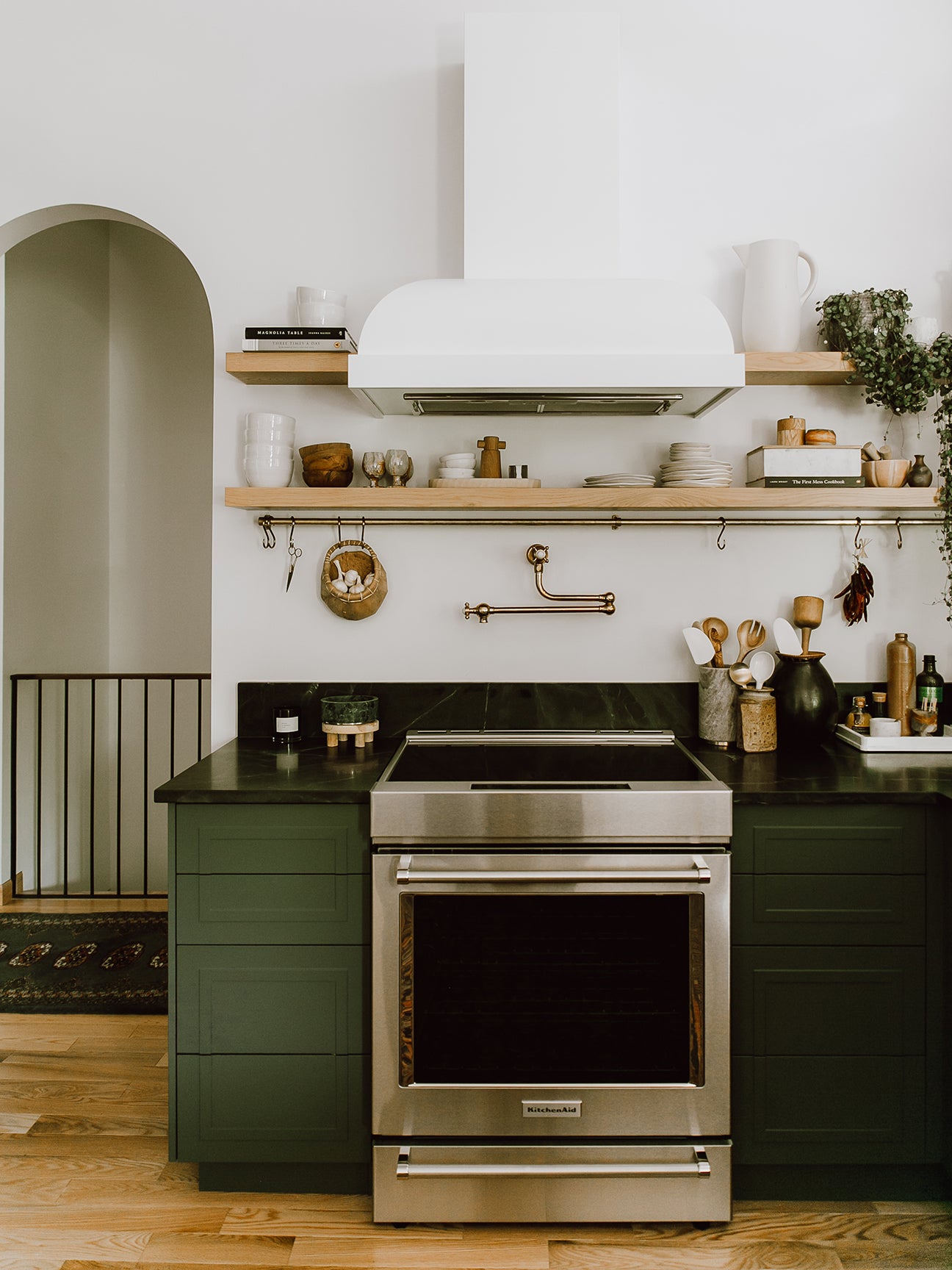 dark green kitchen with white hood