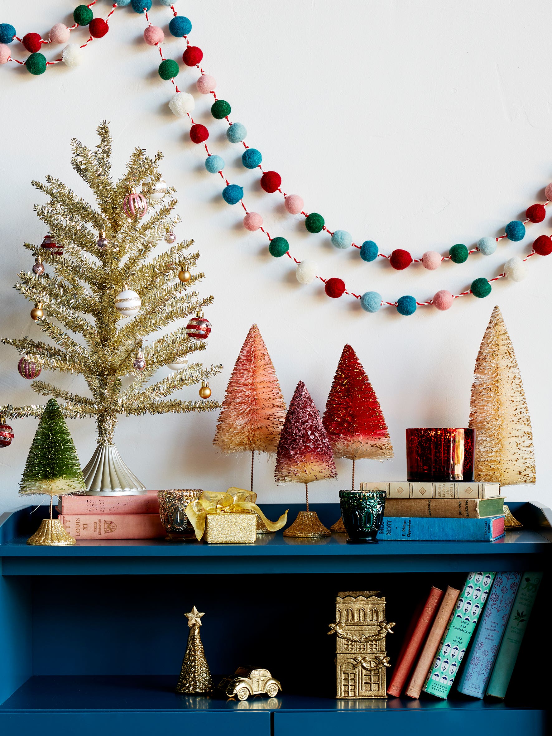 blue-bookshelf-colorful-christmas-decorations