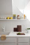 White rental kitchen with yellow accessories