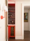 Red wet bar in closet by Studio DB