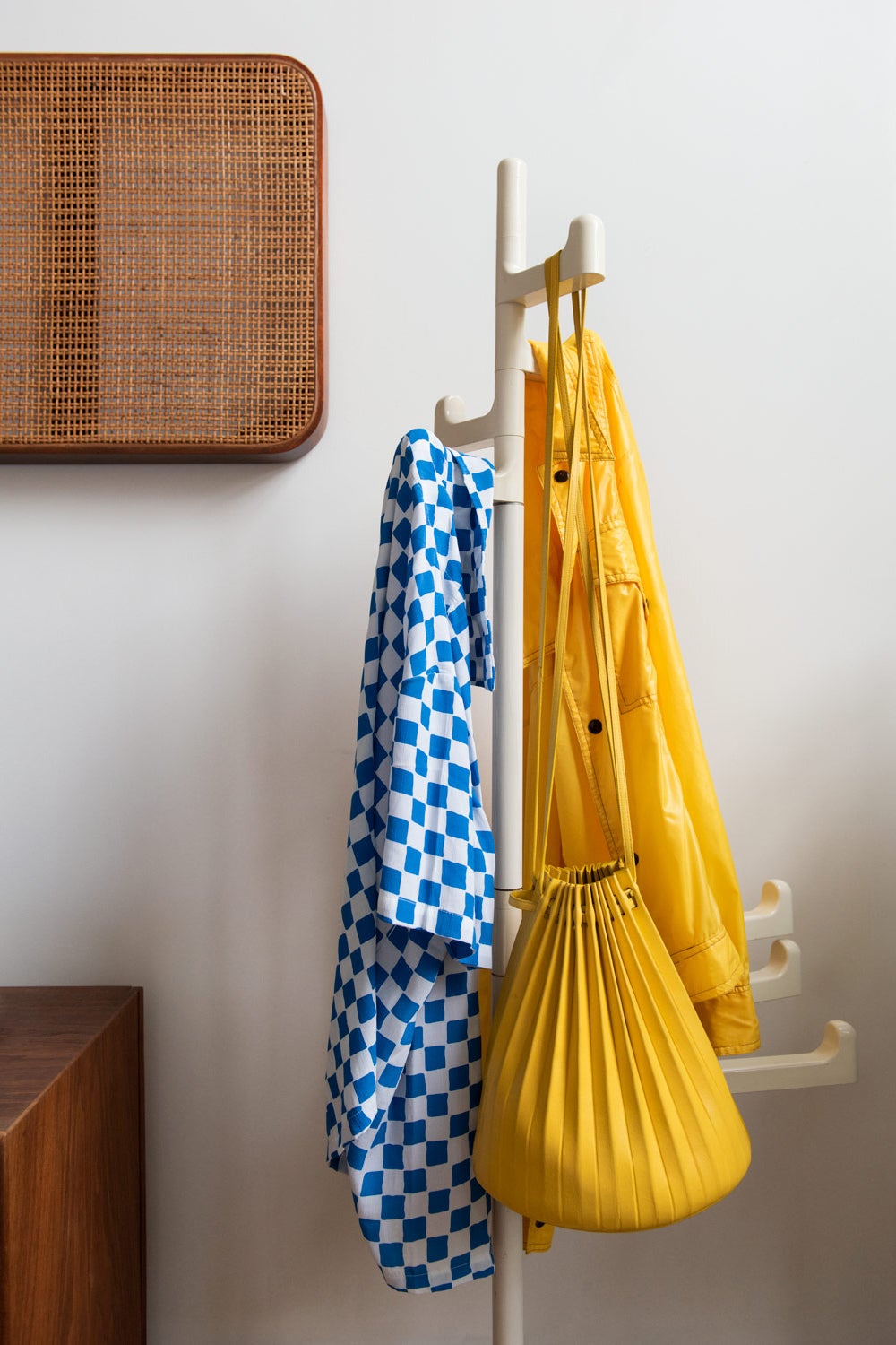 Blue and yellow coats on rack