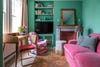 Bright green living room with pink sofa