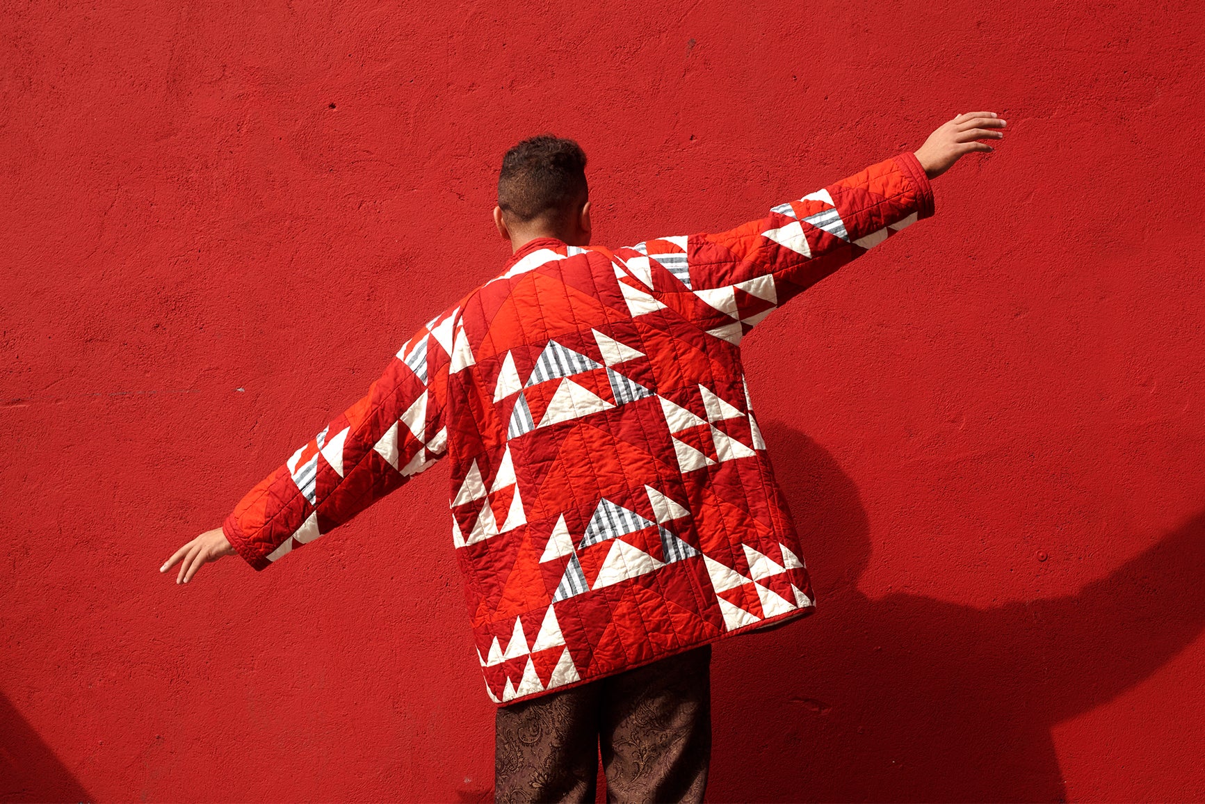 man with red quilt coat