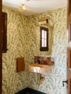 Powder room with green leafy wallpaper