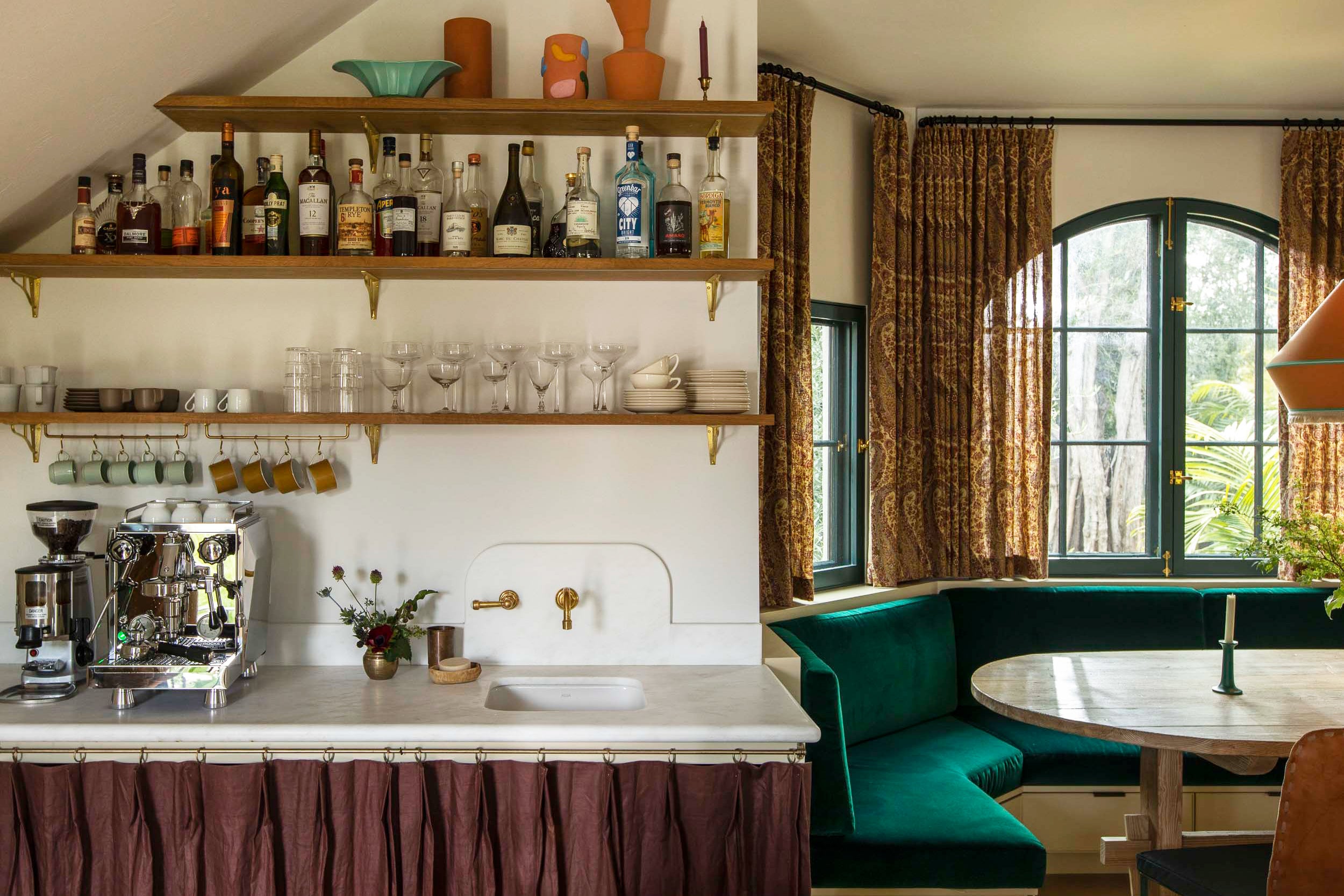 Kitchen with plum sink skirt and green velvet banquette