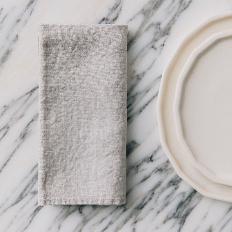 light grey napkin on a marble table surface