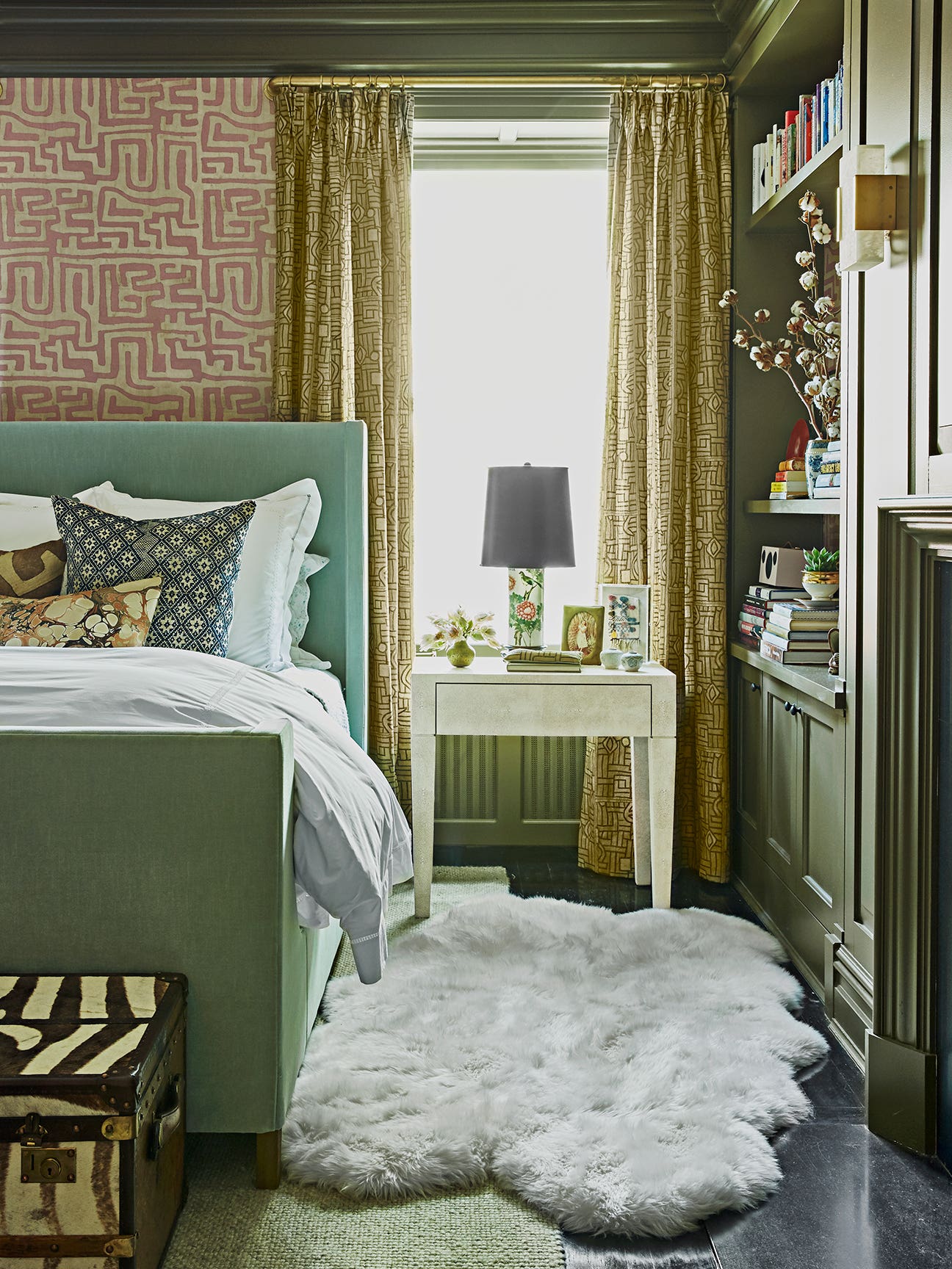 Green bedroom with sheepskin rug