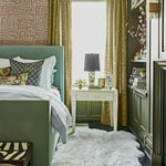 Green bedroom with sheepskin rug