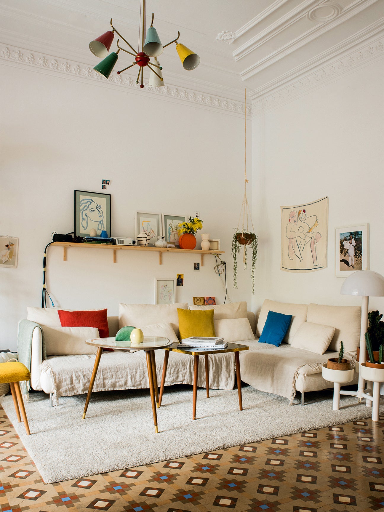 Primary color pillows in all-white living room