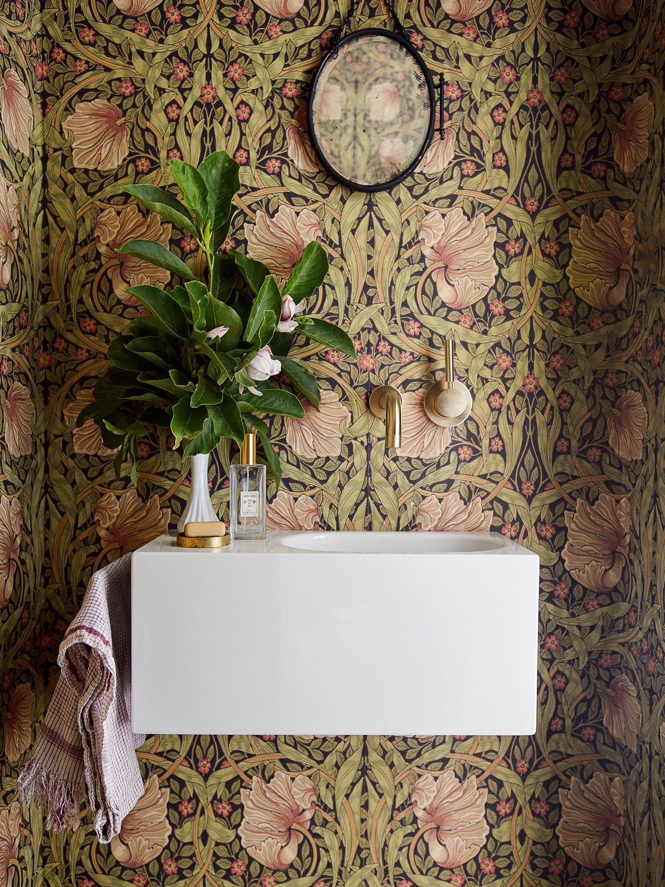 Powder room with floral wallpaper