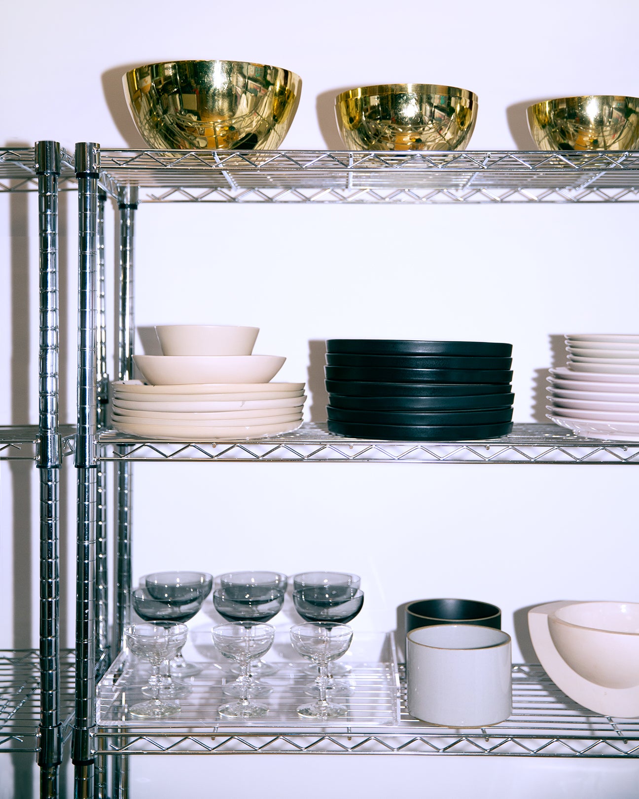 wire shelves with bowls and plates stacked