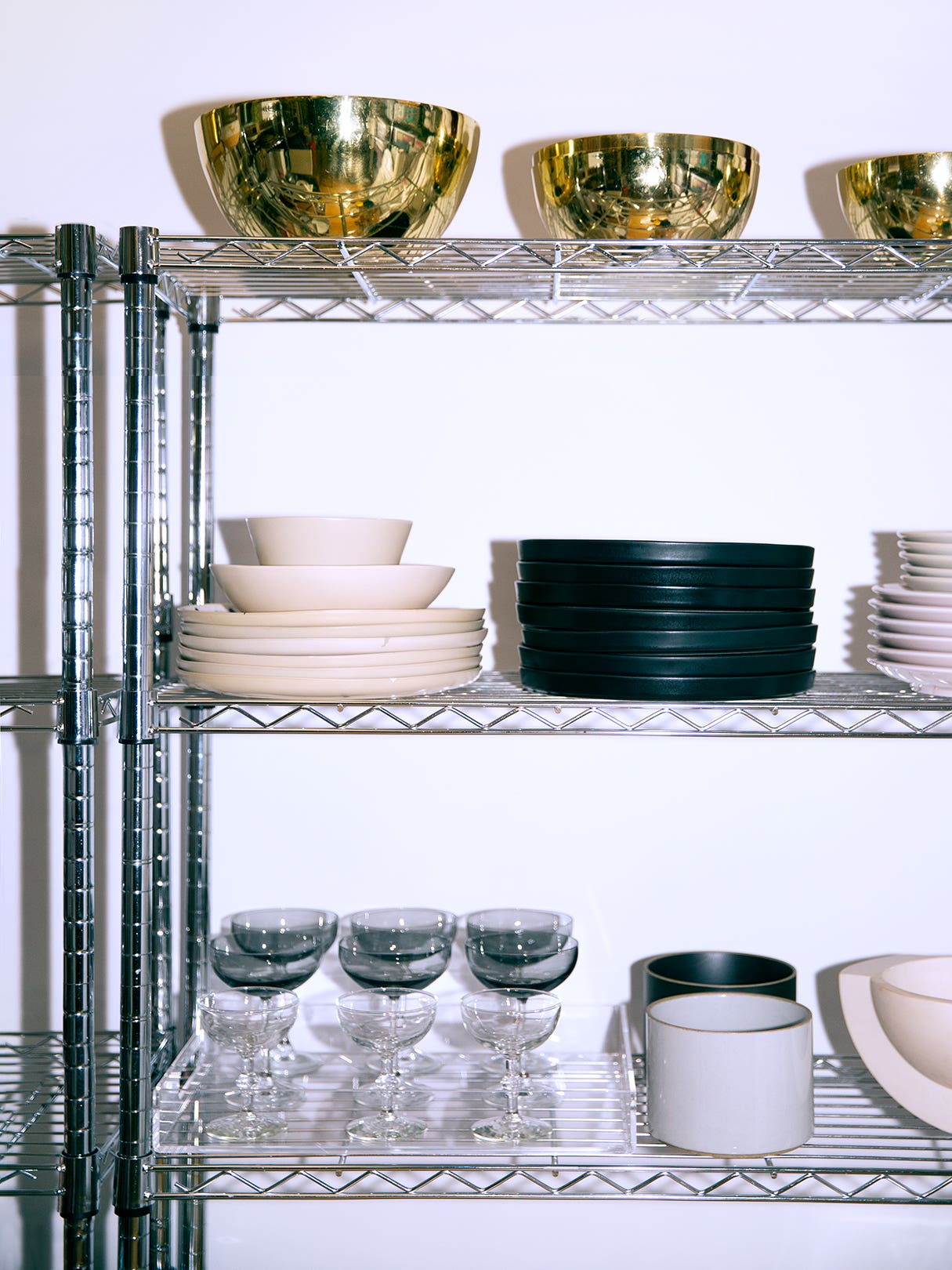 wire shelves with bowls and plates stacked