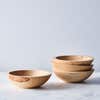 four wood bowls on a light background