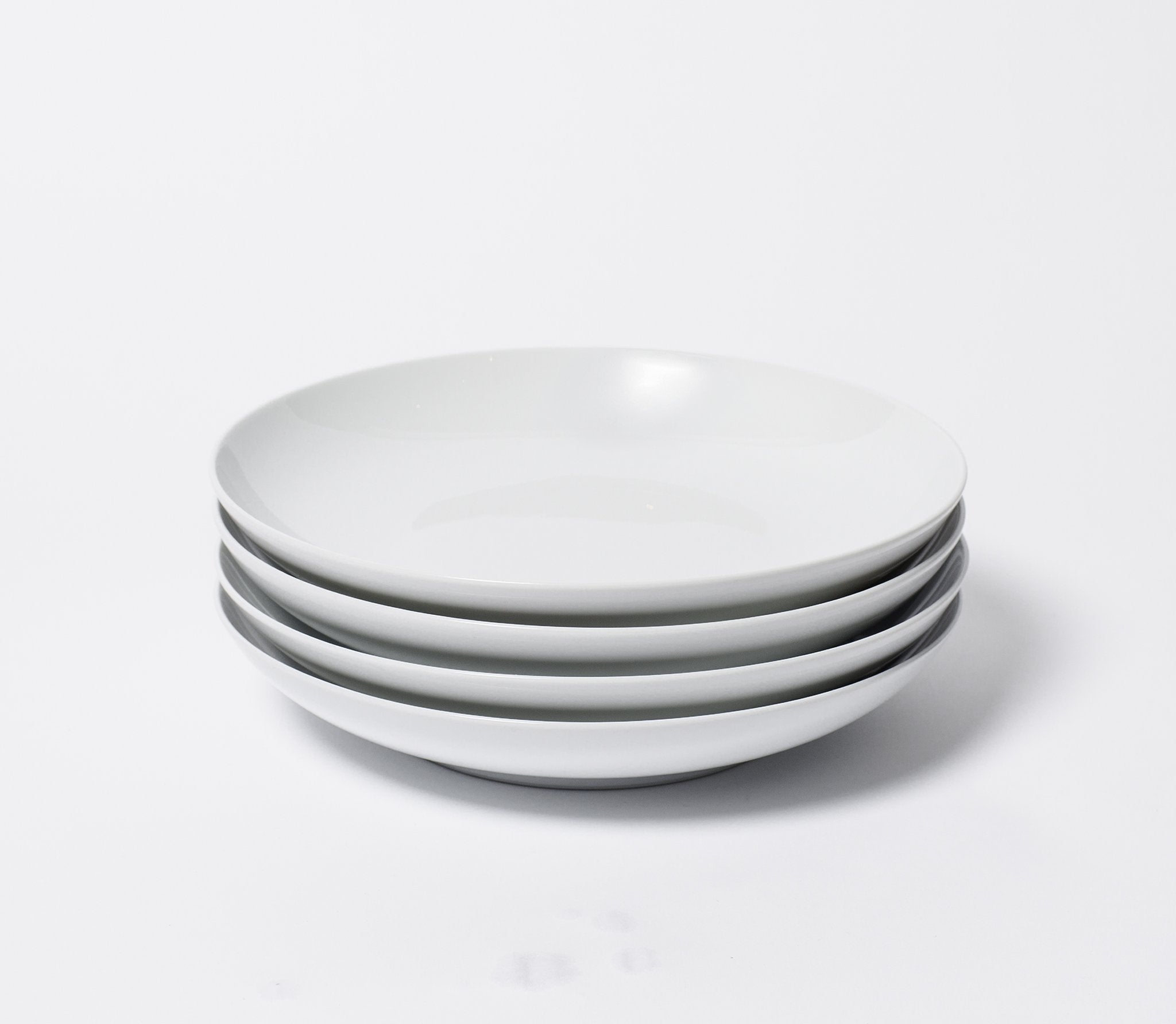 stack of four white dinner bowls