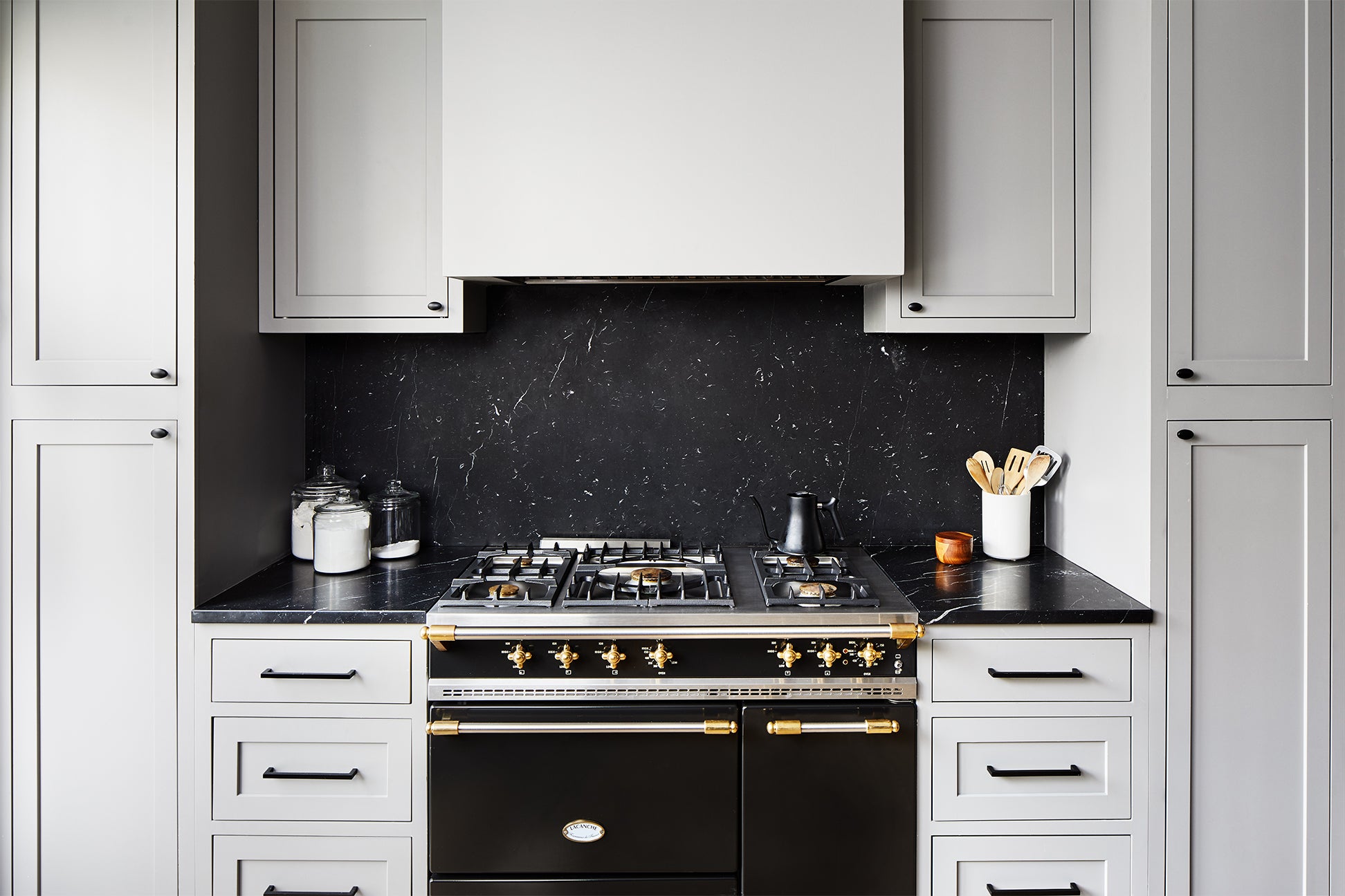 Kitchen with black countertops and Lacanche range