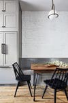 Gray dining banquette with black chairs