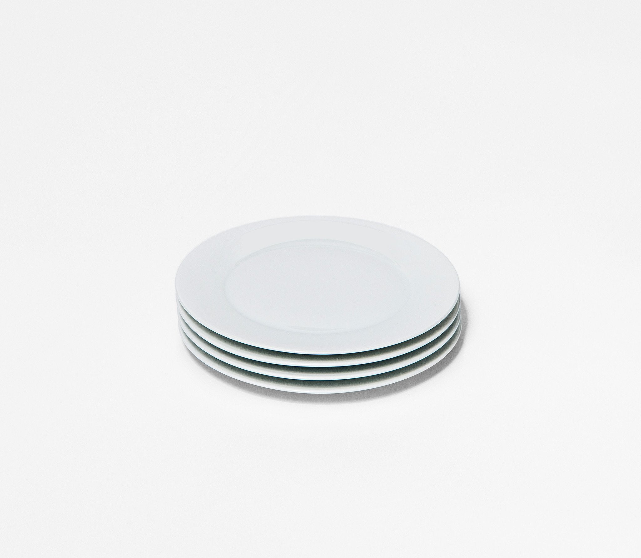 stack of four small white plates