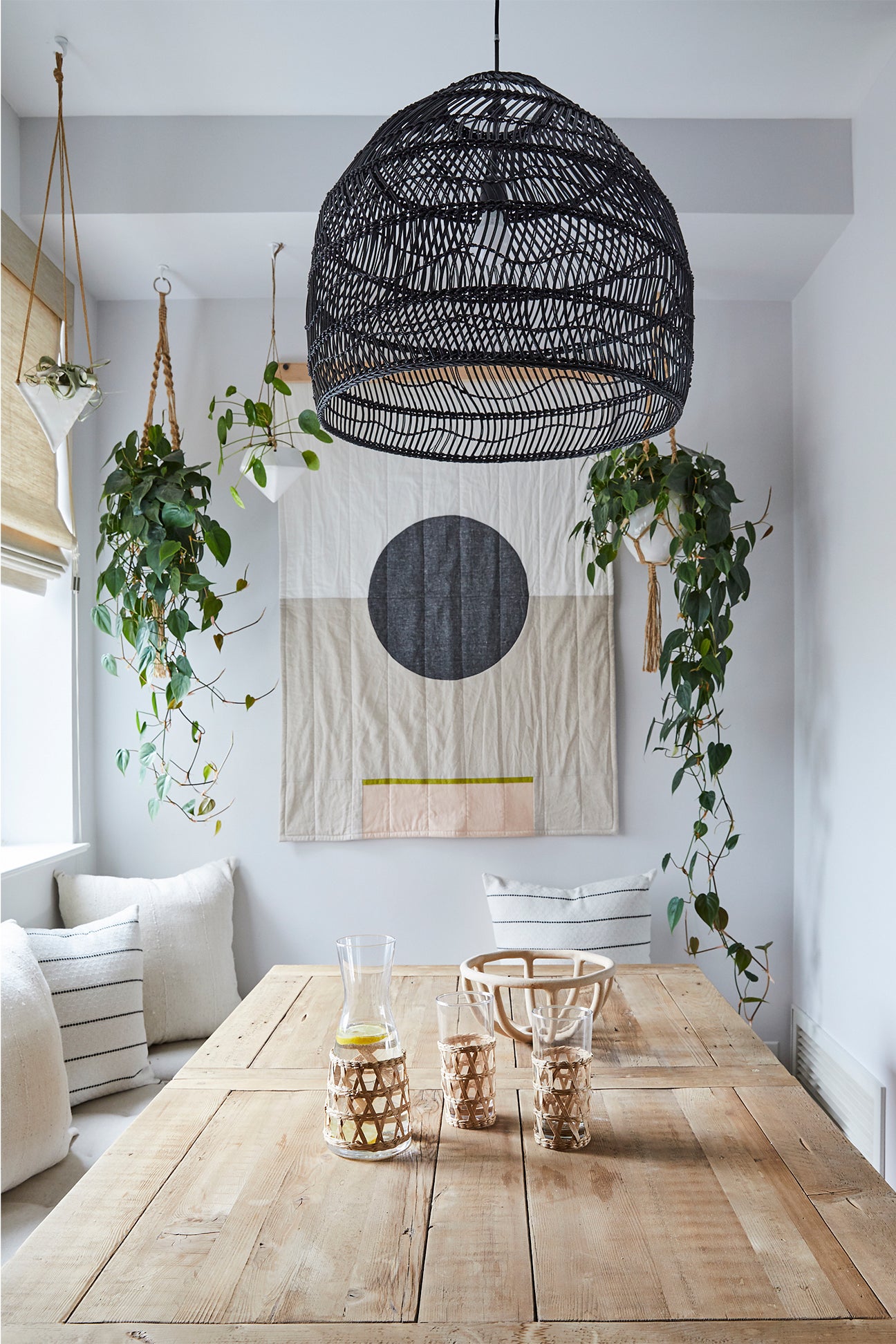 Dining nook with plants and wall hanging