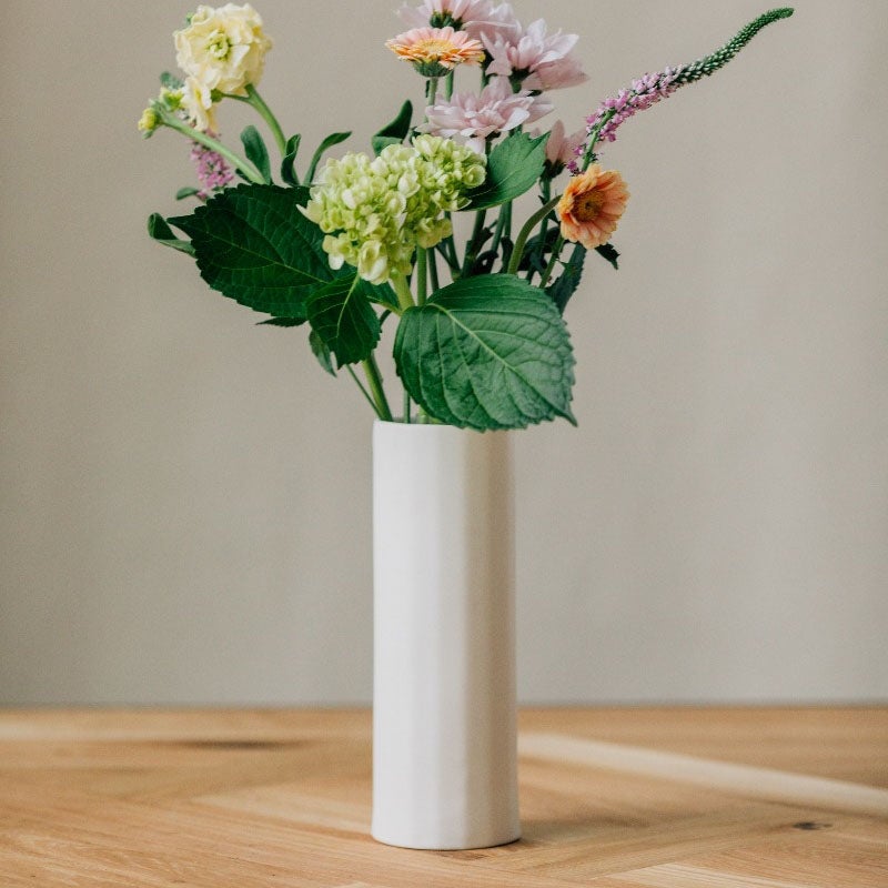 simple white vase with floral arrangement