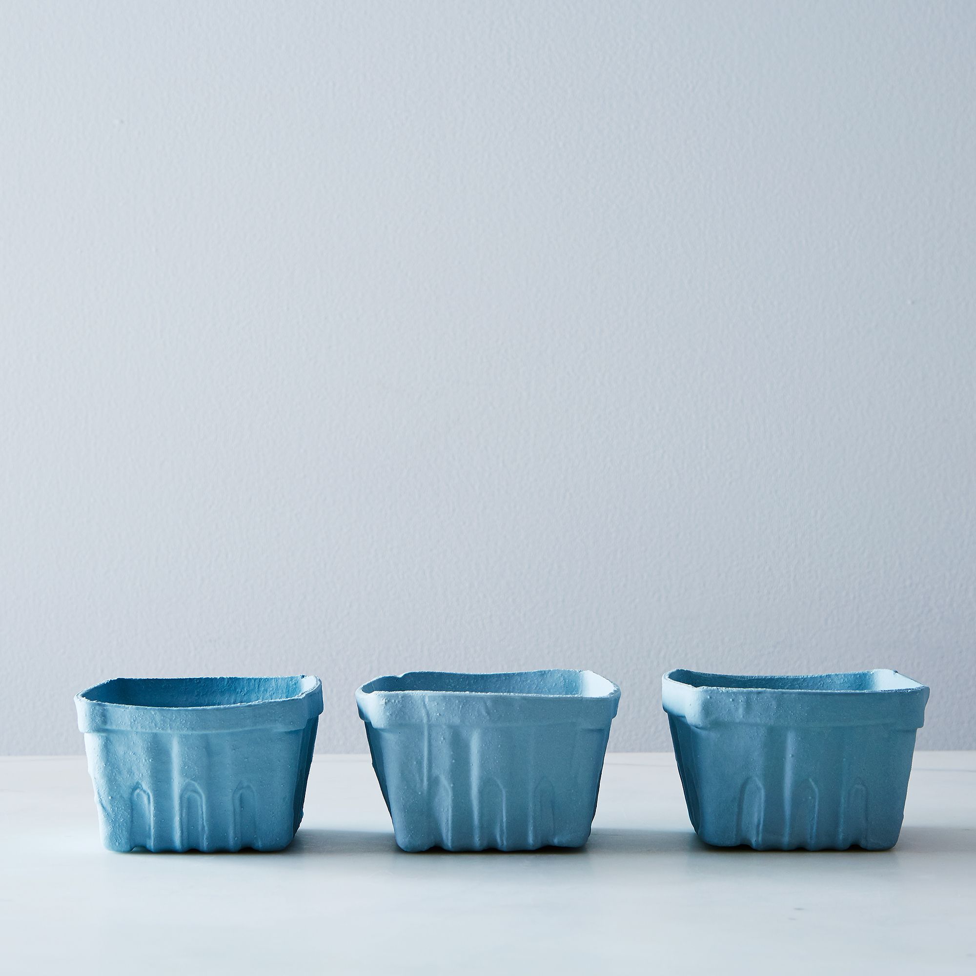 three blue porcelain berry baskets