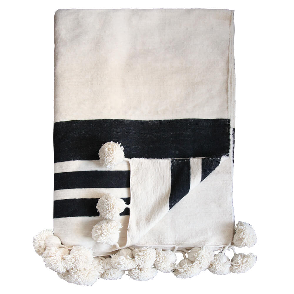 Black and white throw blanket with pom poms