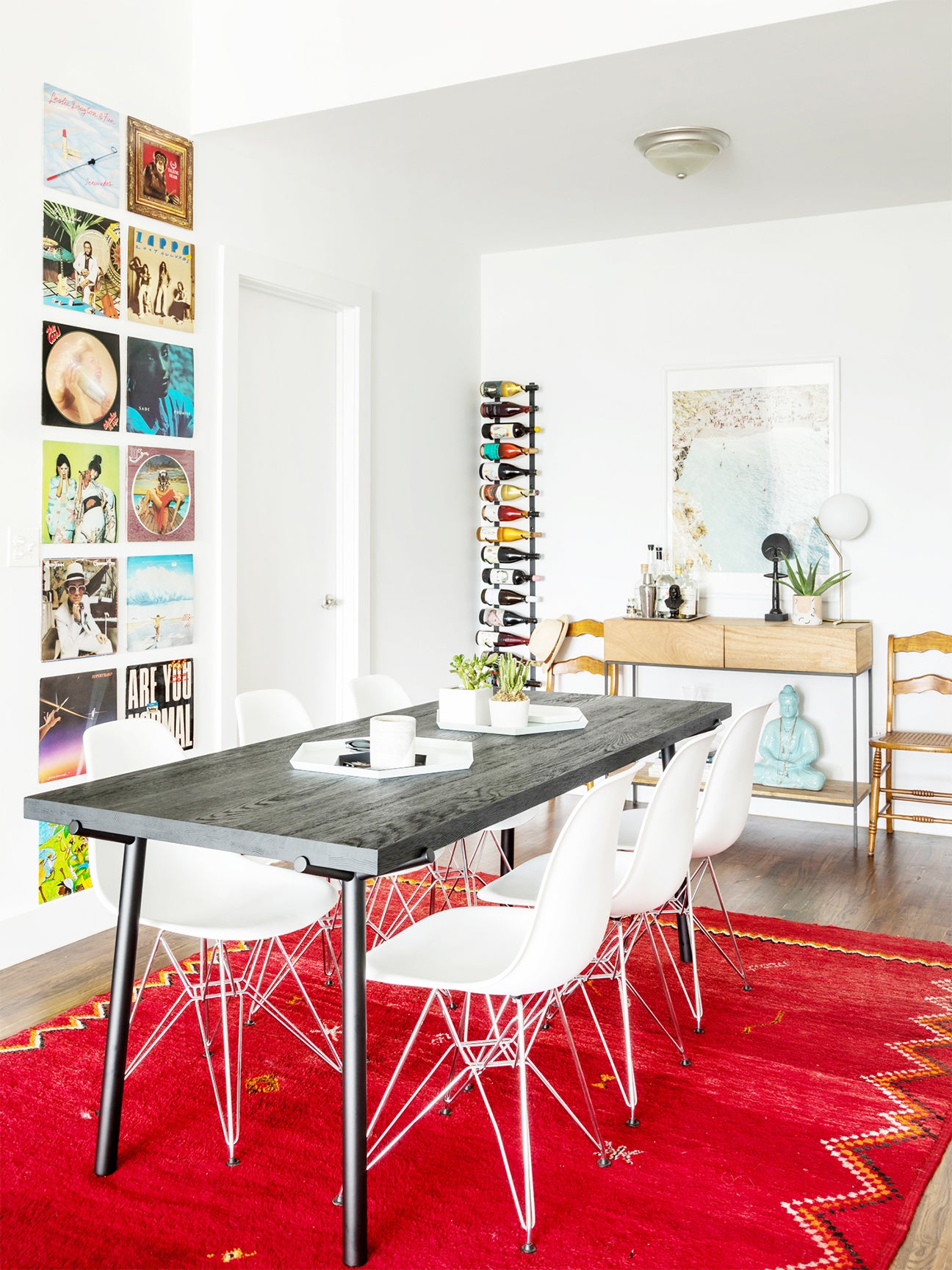 dining room with red carpet and gallery wall