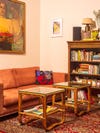 Living room with orange sofa, coffee table, and bookshelf