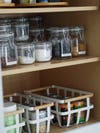 baskets and clear canisters on a shelf