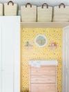 yellow wallpaper accent wall over the changing station