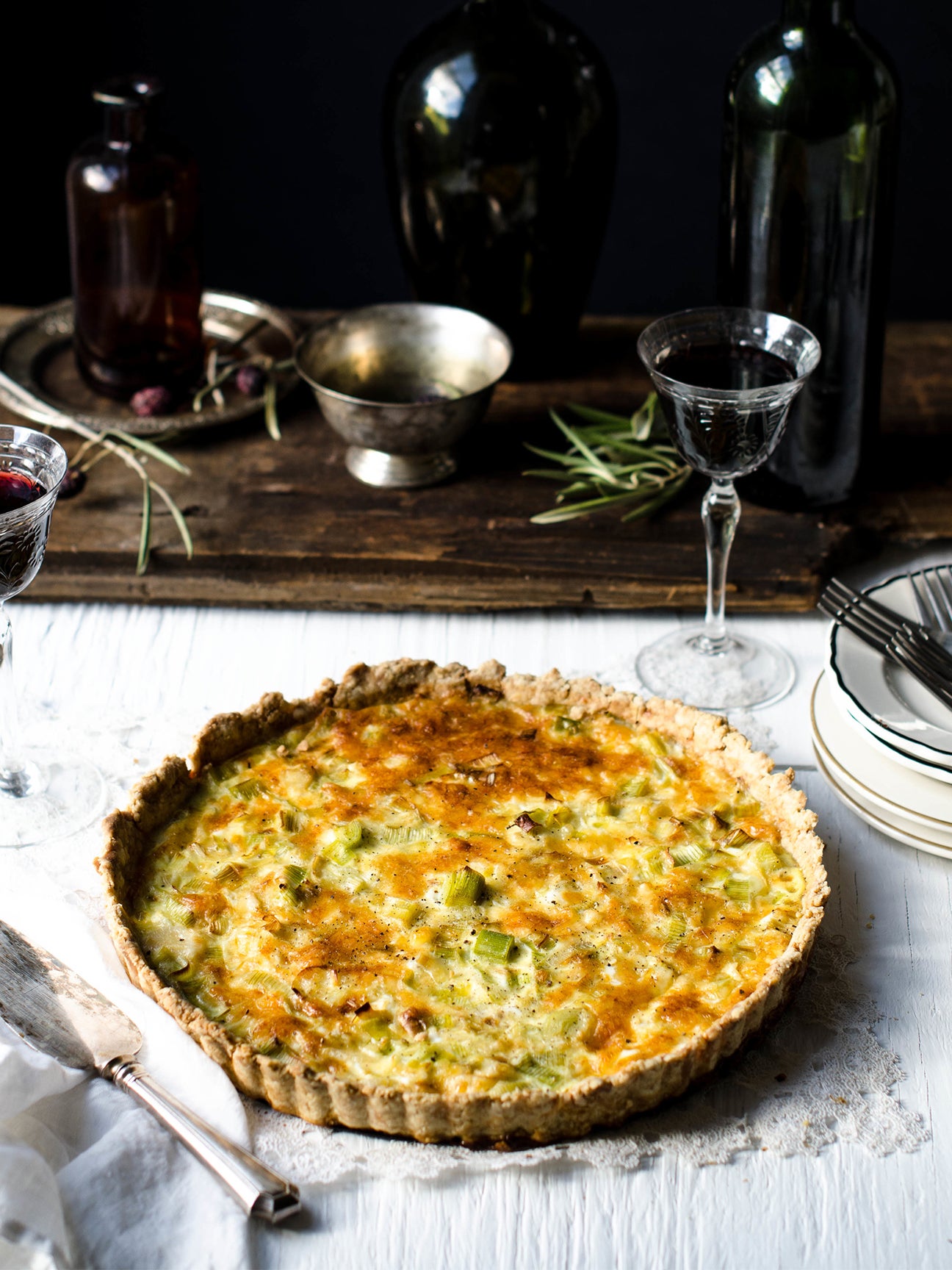 gruyere and leek quiche with wine glasses