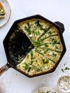 quiche in cast iron skillet with asparagus