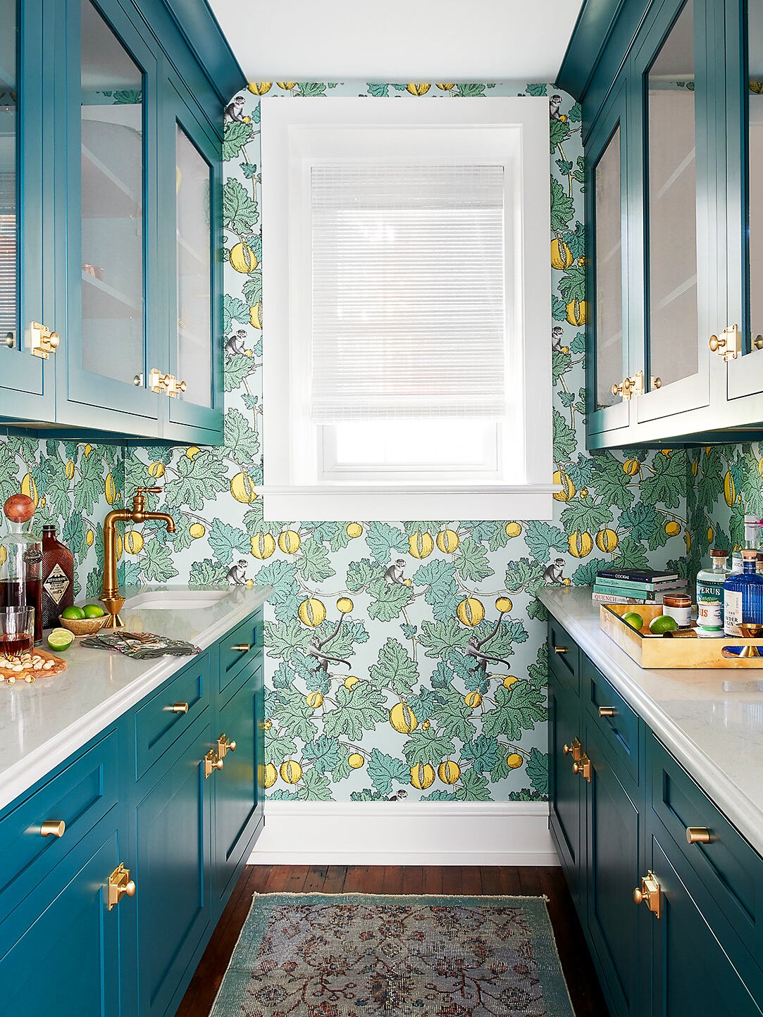 Teal pantry with fruit wallpaper