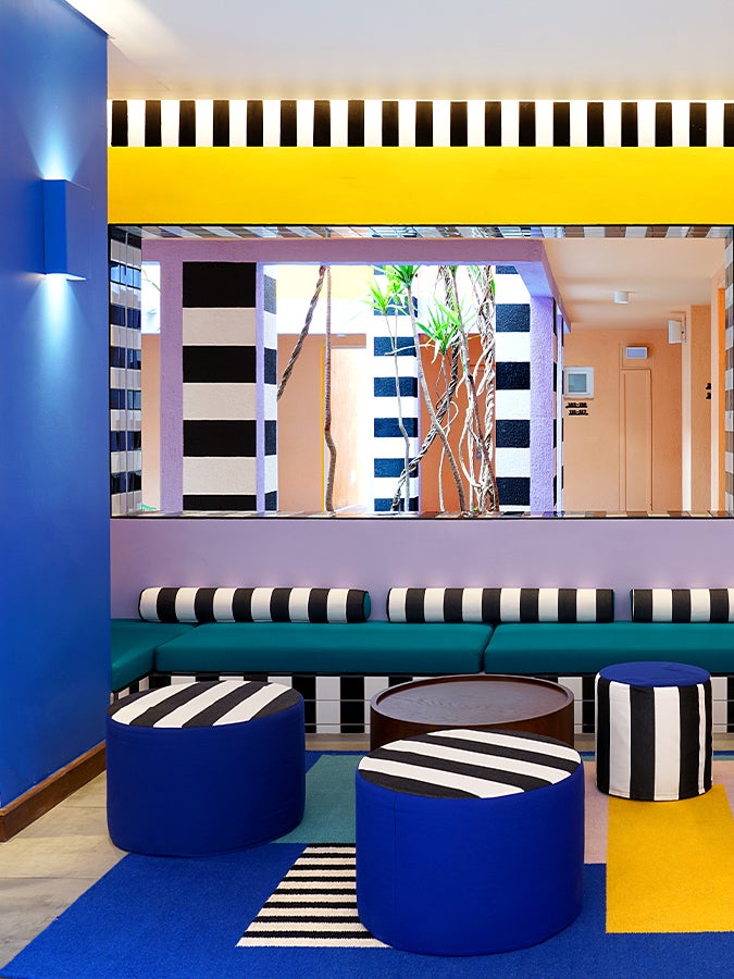 Memphis milano room with blue, yellow, purple accents and seating