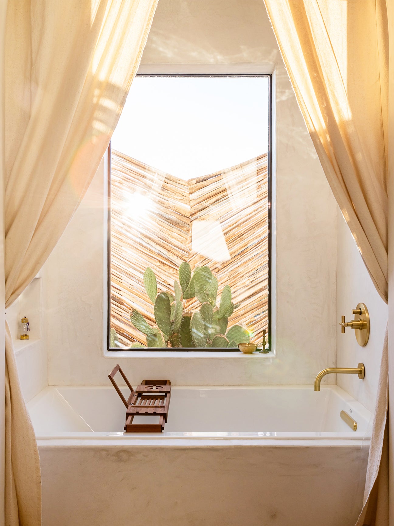 Plaster bath tub with cream curtains