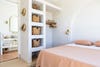Joshua tree vacation rental with pink bedspread and plaster closet