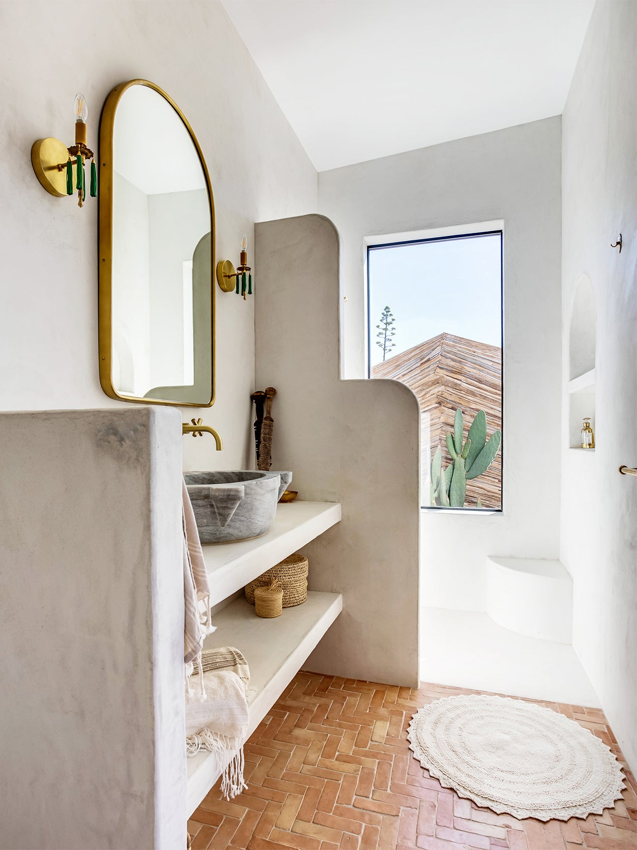 Bathroom with plaster walls and brass fixtures