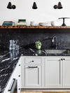 dark marble counters with cool gray cabinets and open wood shelving
