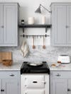 cool gray cabinets with marble backsplash and hook bar