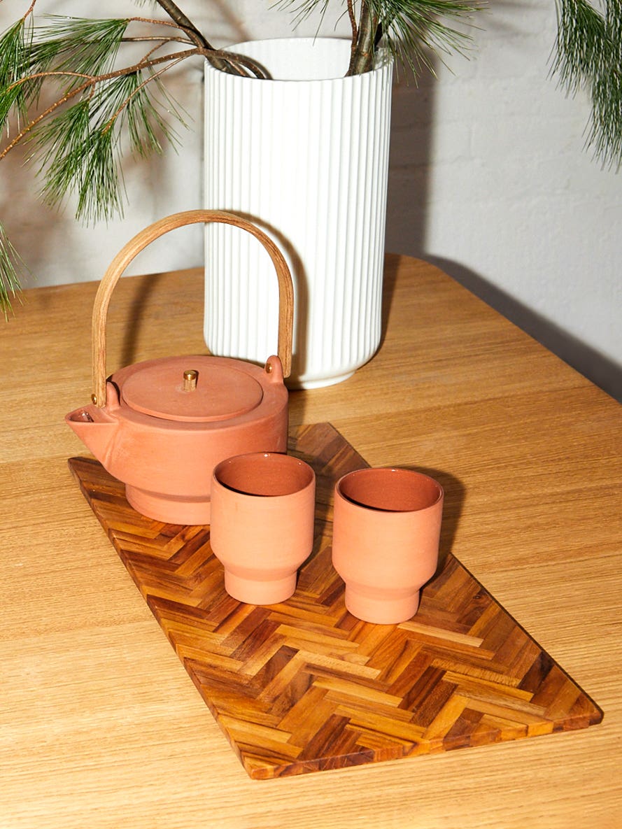 terra cotta teapot and cups on table