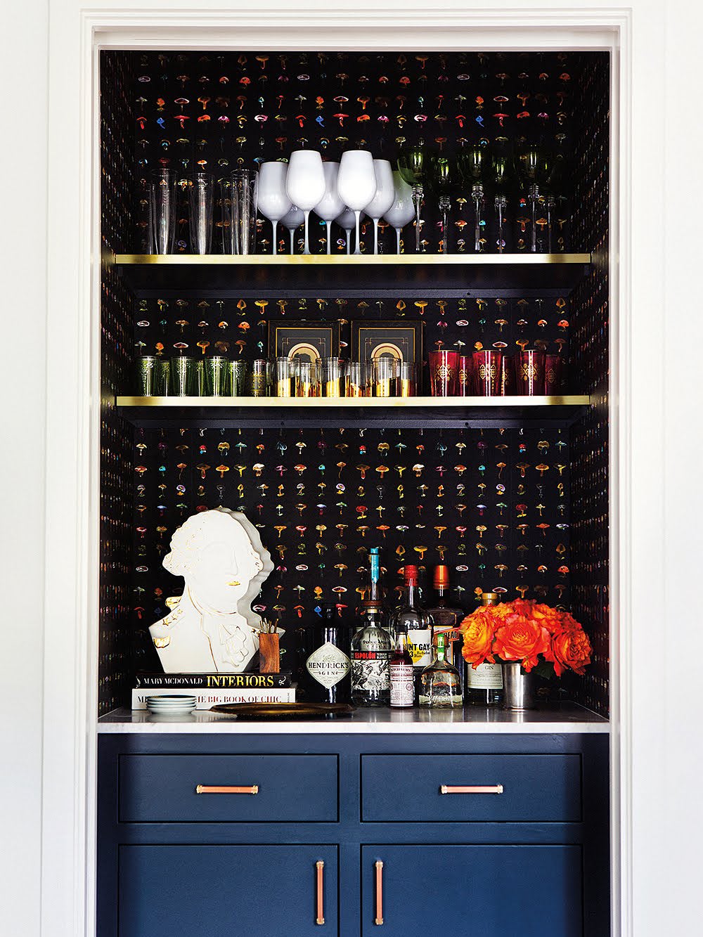 cut out shelving with bar and sink and stacks of glasses