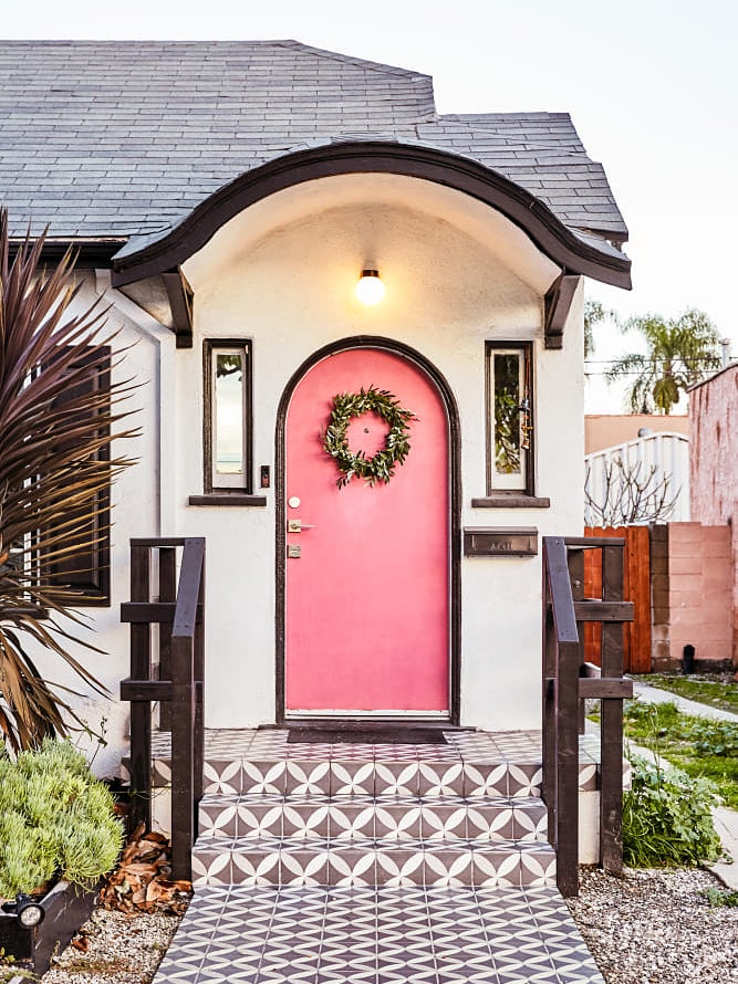 small home with a pink front door