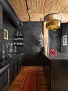 Black kitchen with red and wood accents