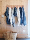 pairs of jeans hanging from a wall