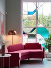pink sofa in front of stained glass window
