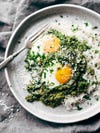 green shakshuka with fried eggs