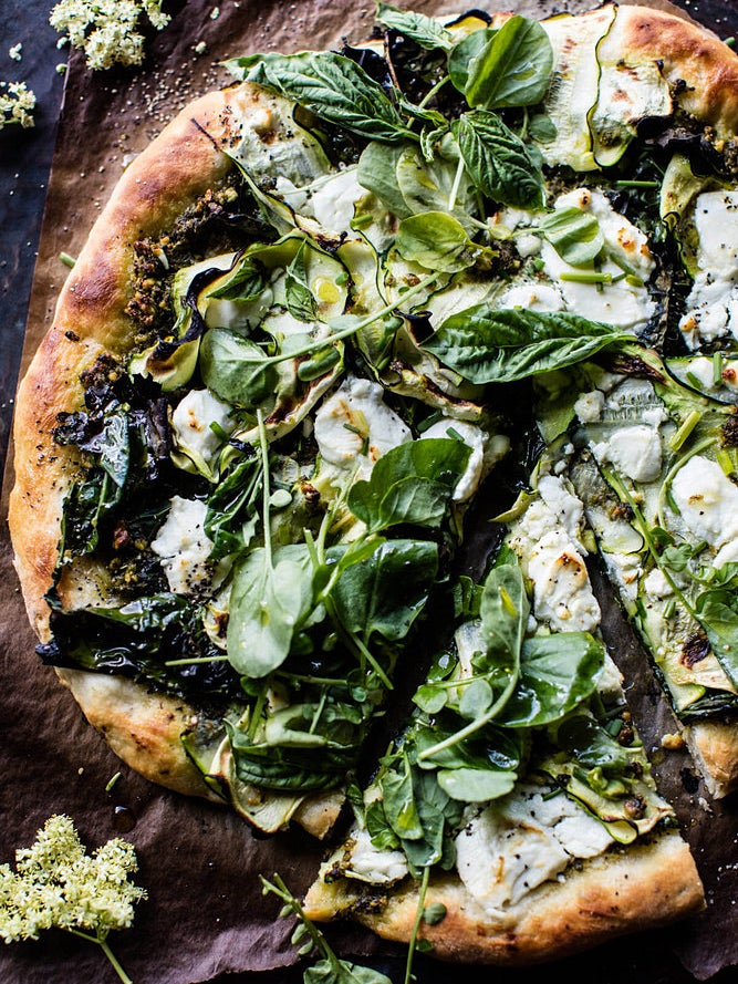 pizza with greens on it