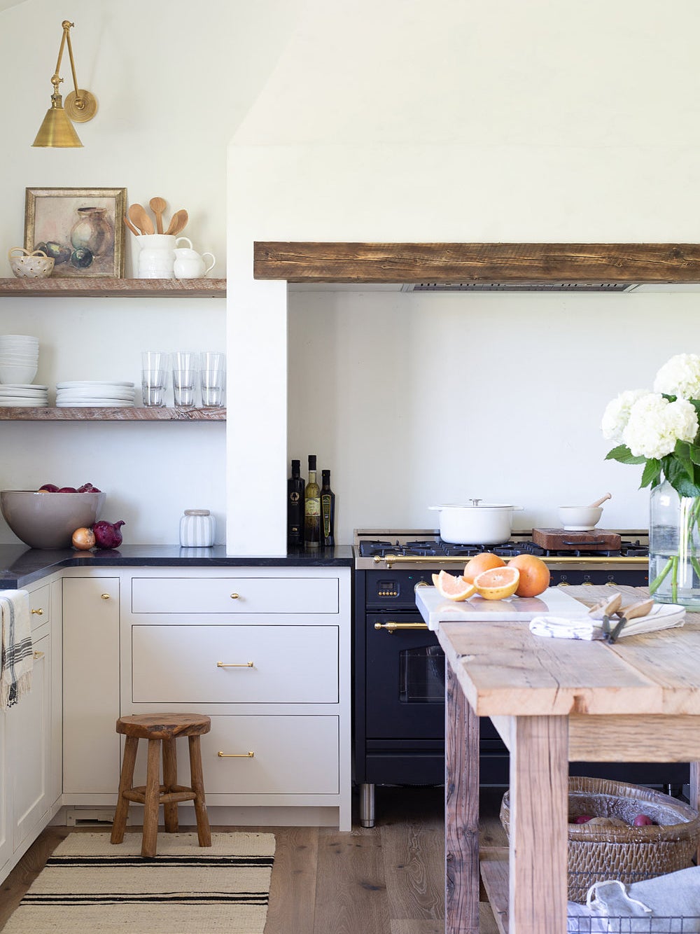 rustic white kitchen with wood slab over the range