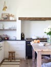 rustic white kitchen with wood slab over the range